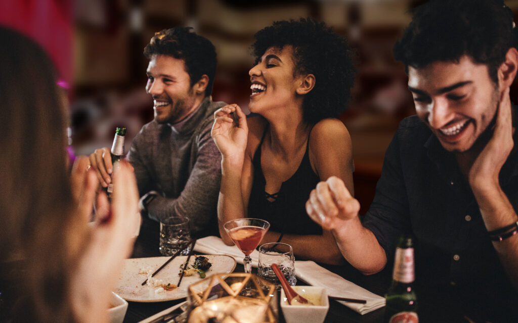 a group of young adults enjoying food and company