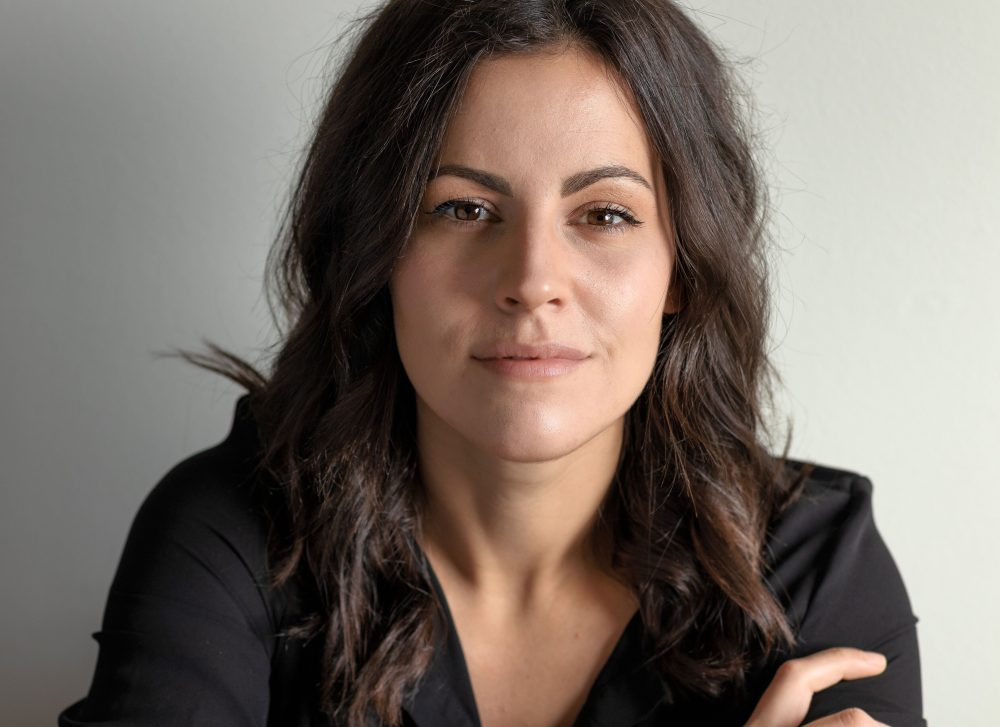 a woman who is smiling and looking at the camera